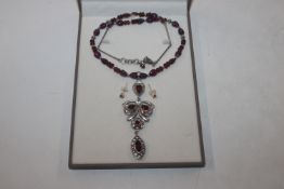 A Sterling silver garnet and white sapphire neckla