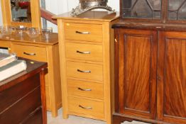 A light oak chest fitted five long drawers