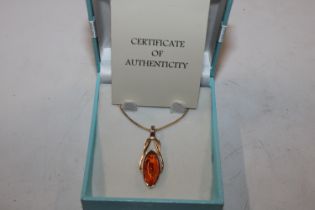 A Sterling silver gilt amber set pendant hung to a