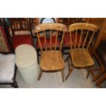 A pair of elm seated and stick back chairs; and a