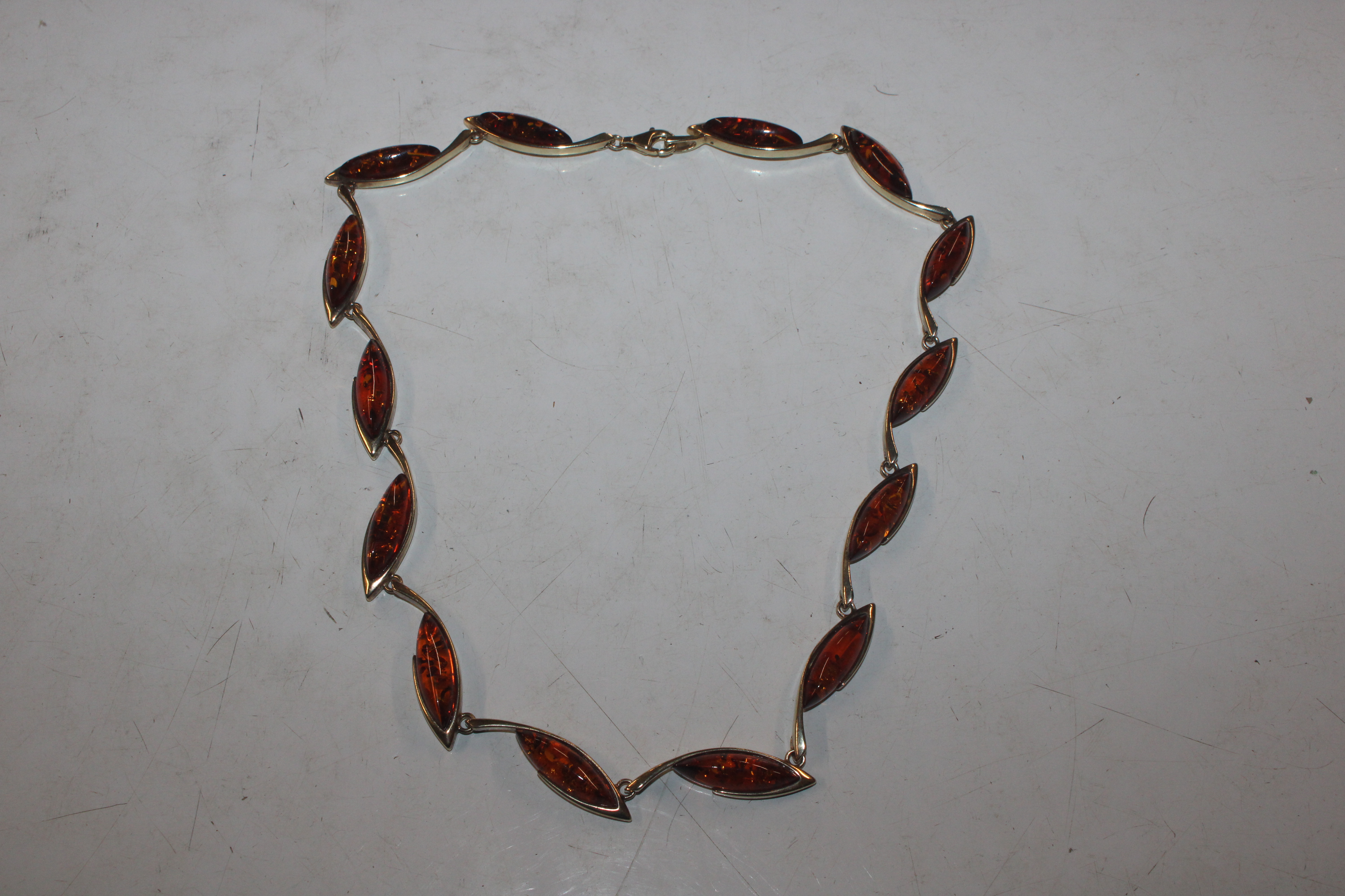 A Sterling silver gilt and amber leaf link necklac
