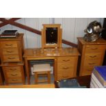 A light oak dressing table with fitted three drawe