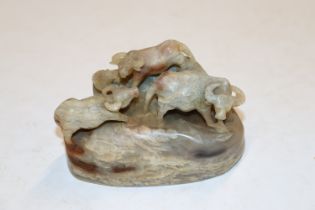 A polished carved stone group of water buffalo