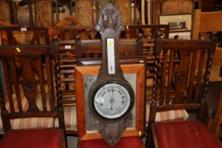 An oak mounted barometer and two framed mirrors