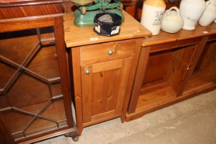 A pine cupboard fitted single drawer