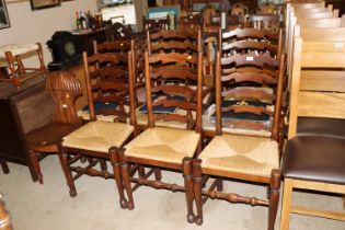 A set of six oak ladder back and rush seated dinin