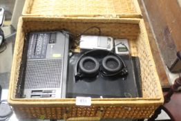 A wicker case containing Sony radio, Canon camera