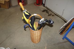 A wicker stick stand and contents of sticks and um