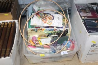 A box of various sewing items and costume jeweller