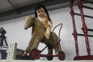 A child's push along toy and doll