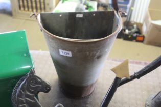 A galvanised wall mounting planter with swing hand