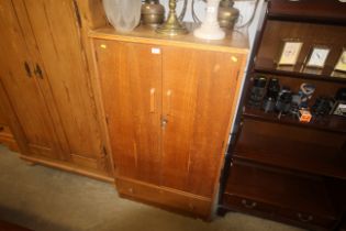 A light oak veneered wardrobe fitted drawer below
