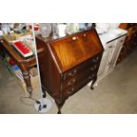 A reproduction mahogany bureau fitted three drawer