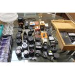 A collection of camera lenses and flash units