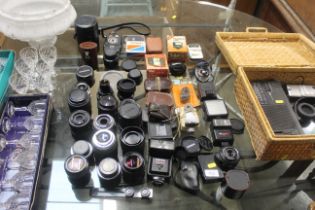 A collection of camera lenses and flash units