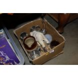 A box containing paperweights, ornaments and tanka