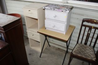 A folding table, two side tables each fitted singl