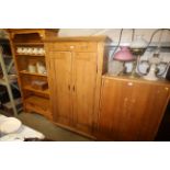 A stripped pine two door wardrobe