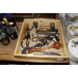 A wooden tray containing vintage hand tools includ