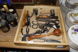 A wooden tray containing vintage hand tools includ