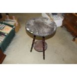 A circular occasional table raised on tripod base