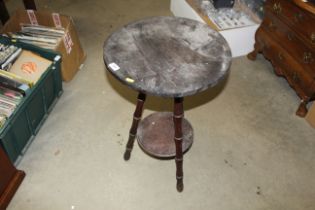 A circular occasional table raised on tripod base