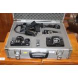 A case containing Minolta X300 camera, a Chinon CE