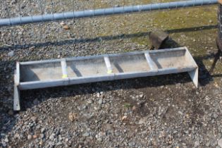 A galvanised four partitioned feed trough