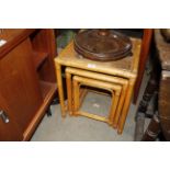 A nest of three cane occasional tables