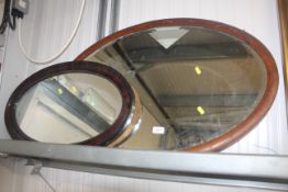 Two oval framed wall mirrors