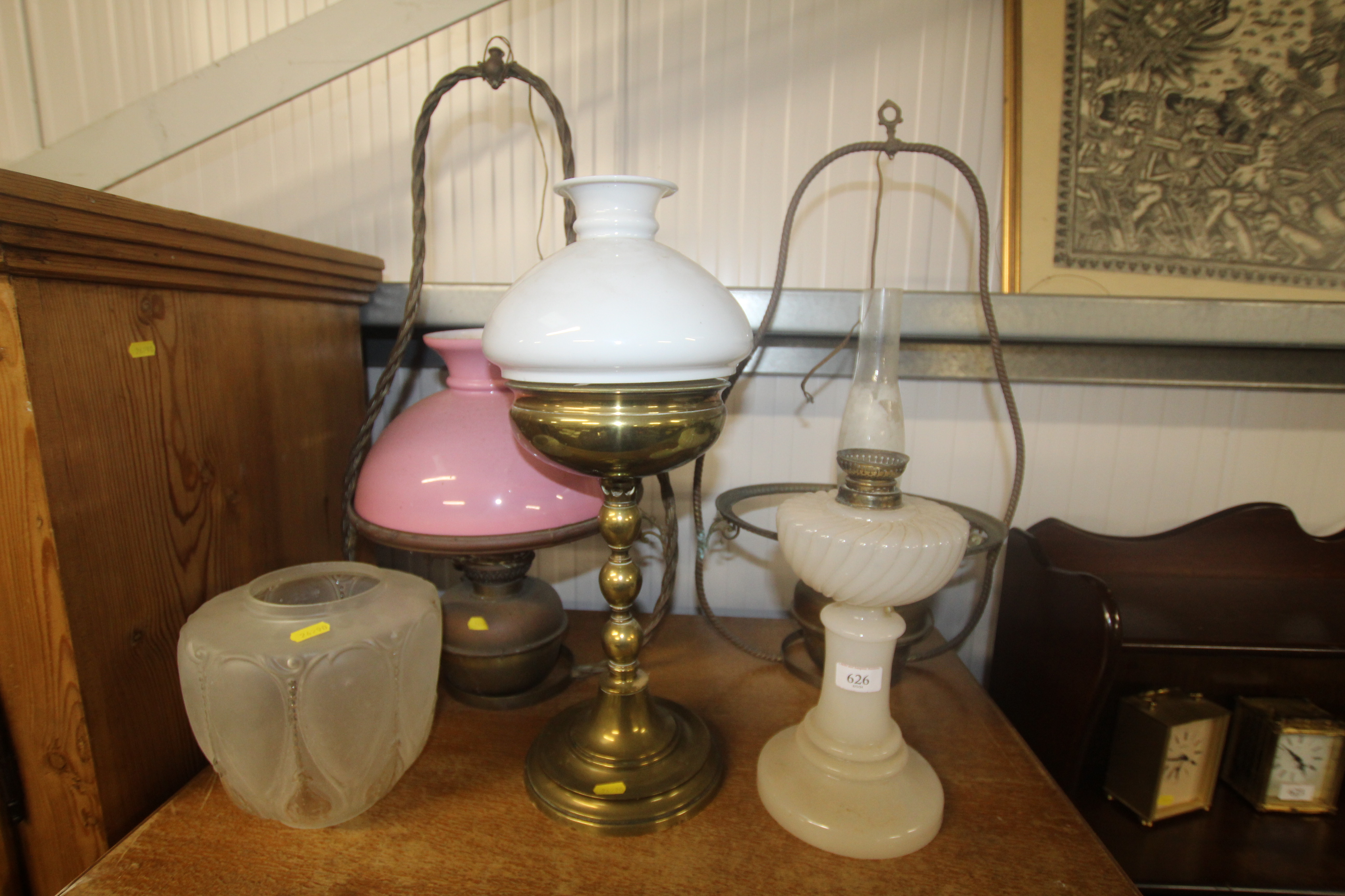 Two brass hanging oil lamps, a brass oil lamp and
