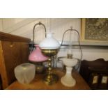 Two brass hanging oil lamps, a brass oil lamp and