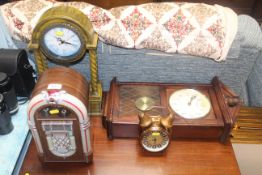A radio in the form of a juke box and three clocks