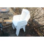 Four white plastic garden armchairs