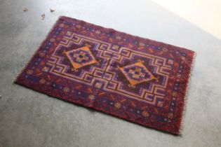 An approx. 4'4" x 2'7" Baluchi rug