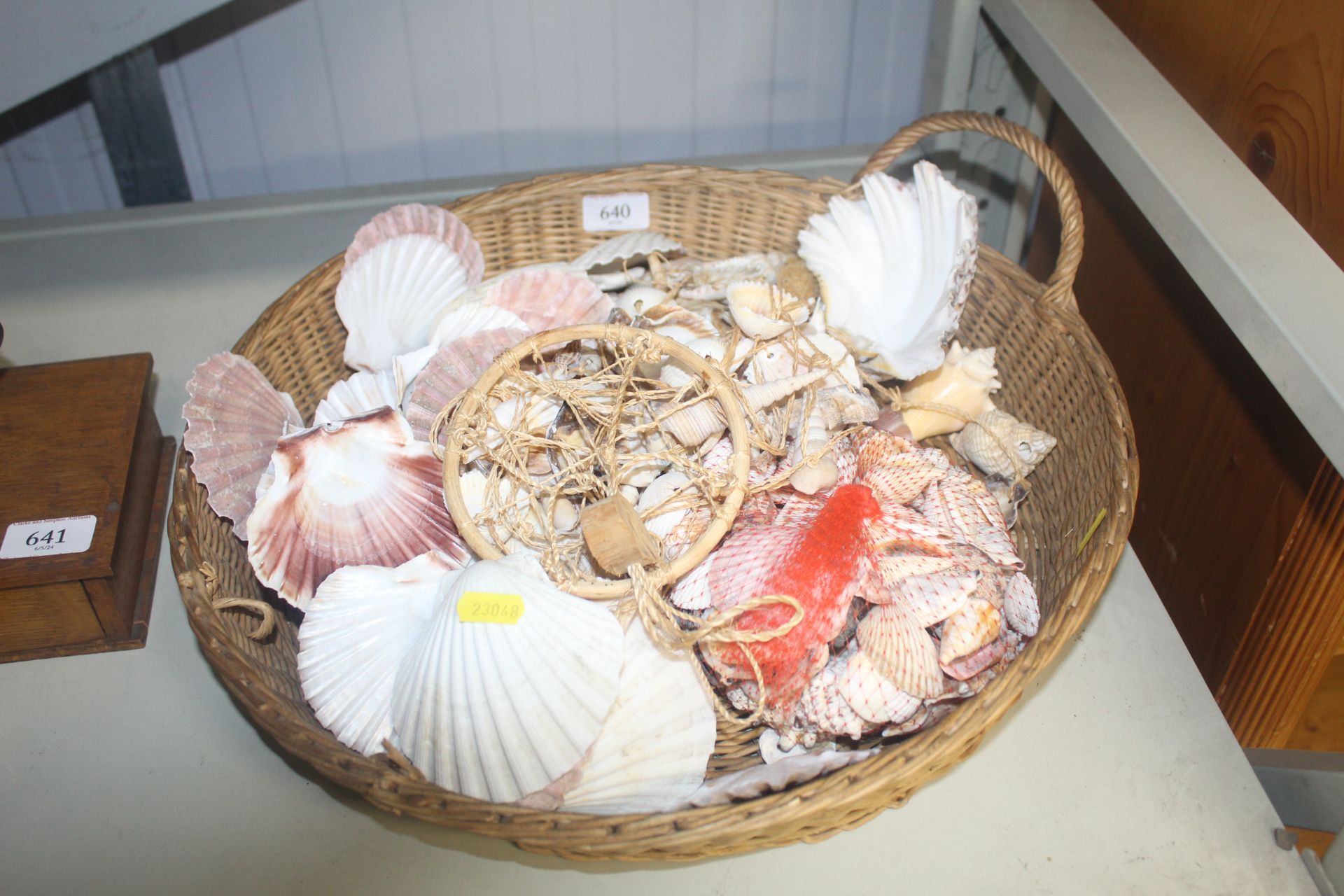 A wicker basket and contents of seashells