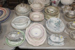 A collection of various patterned dinner ware