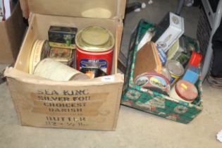 Two boxes of advertising tins