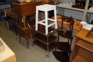 A three tier tea trolley and white painted stool
