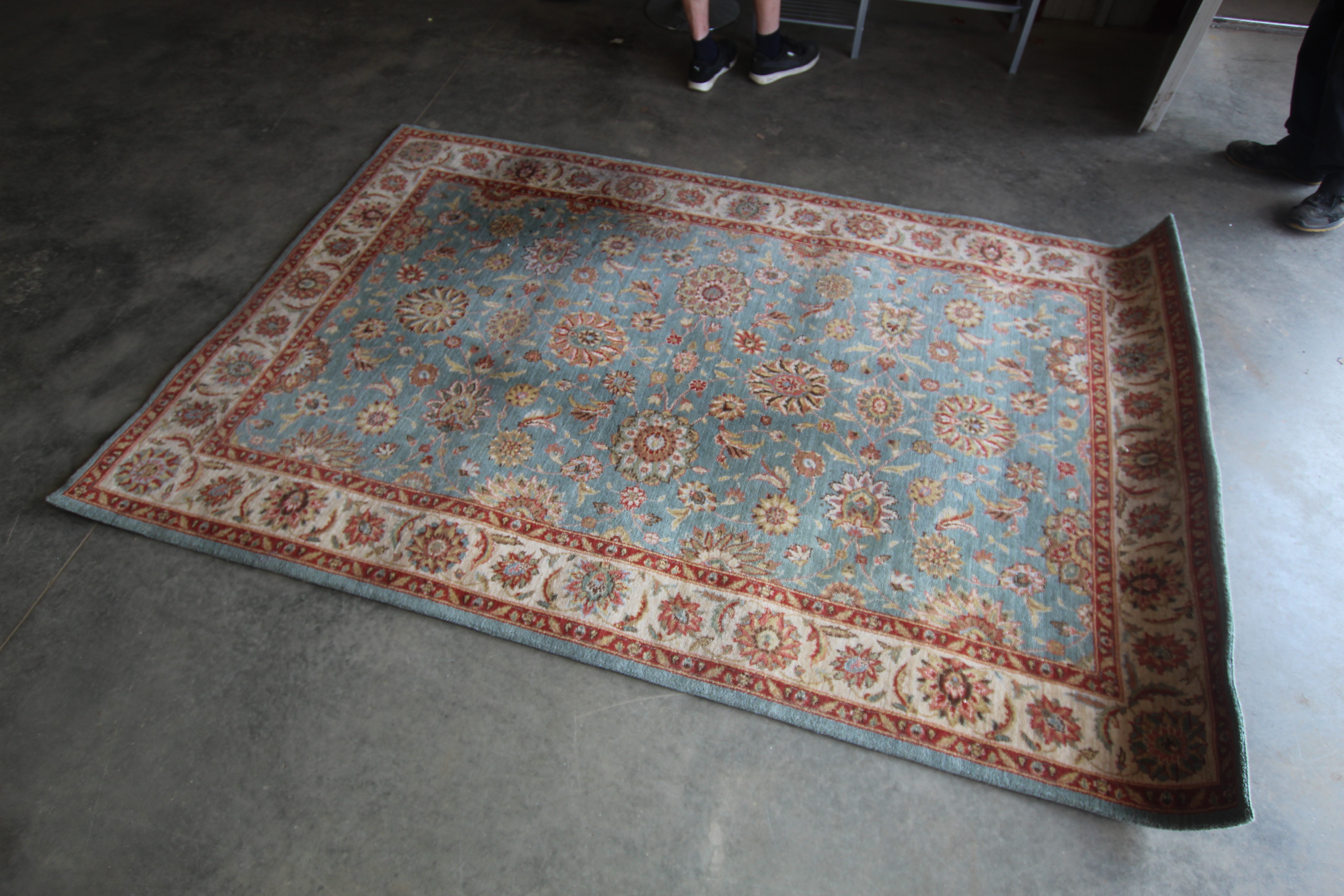 An approx. 8'3" x 5'5" floral patterned rug