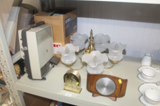 A projector (sold as collectors item), a five branch ceiling light and two mantel clocks