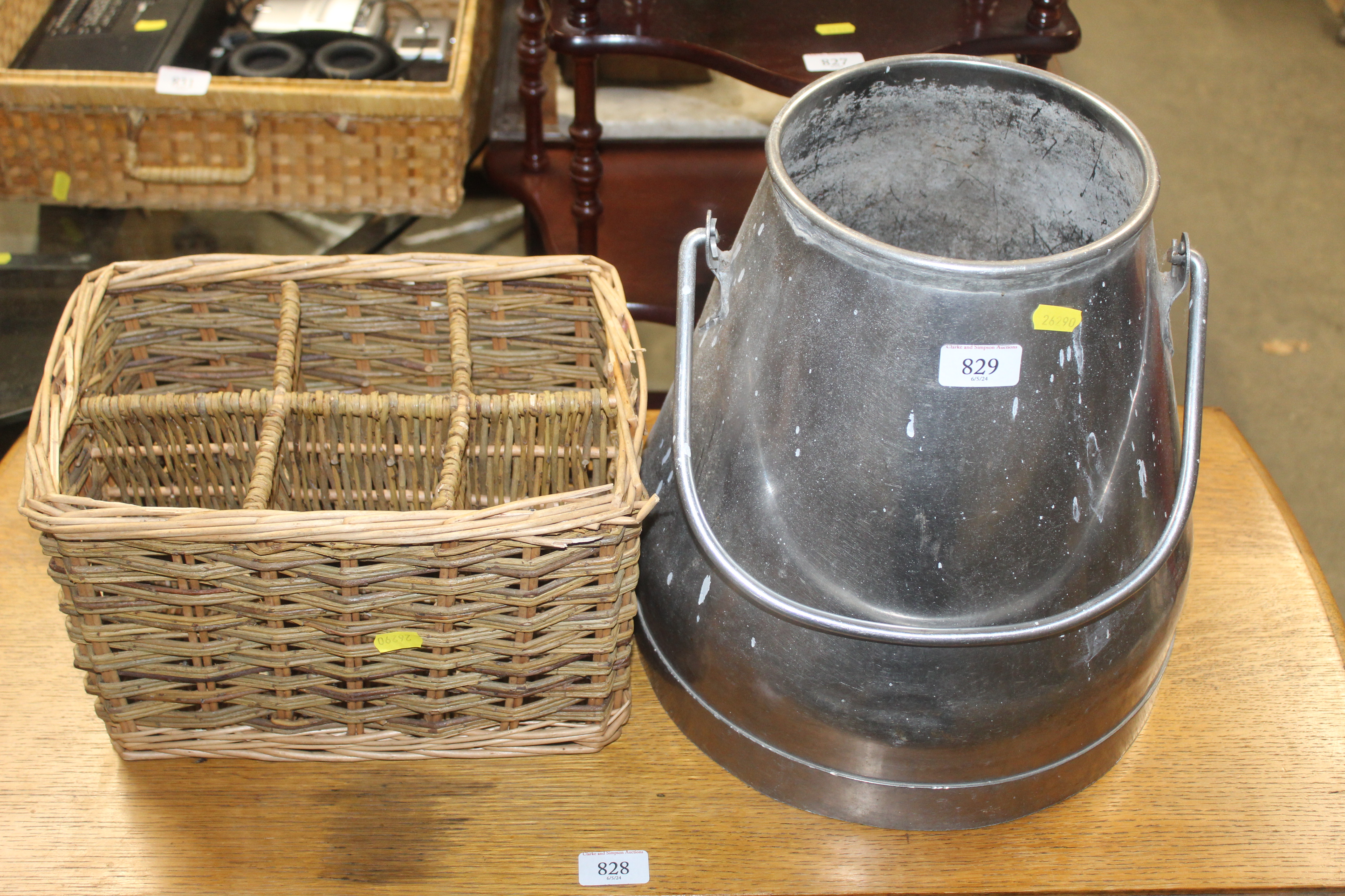 A wicker bottle carrier and milk churn