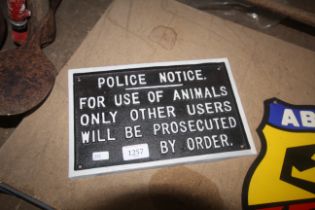 A painted cast iron sign for "Police Notice, for u