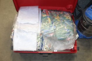 A case containing various linen and curtains