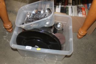 A box containing cutlery, lacquered plates, and co
