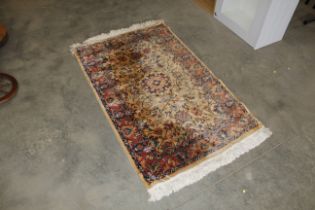 An approx. 5'3" x 3' floral patterned rug AF