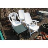 A pair of reclining plastic armchairs, a pair of w