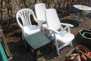 A pair of reclining plastic armchairs, a pair of w