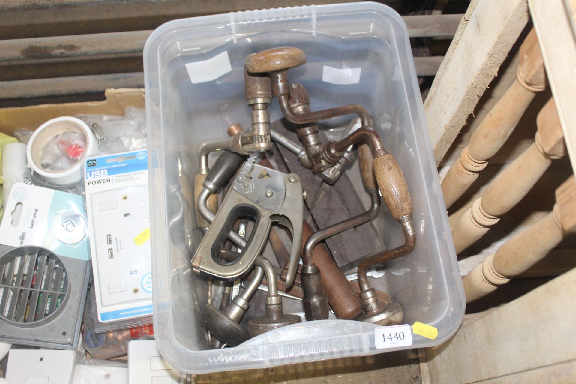 A box containing hand braces, a staple gun etc.