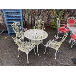 An ornate white painted circular garden table and